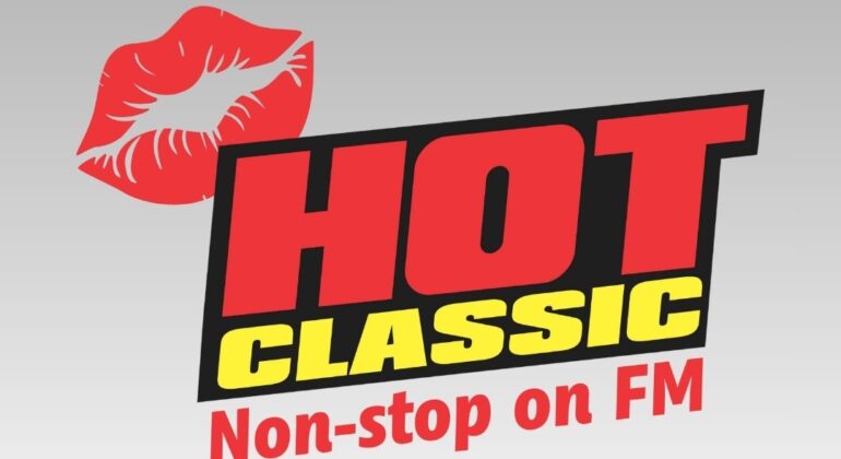 Logo with a red lip print, bold red text reading HOT, yellow text reading CLASSIC, and Non-stop on FM in red below—all set against a gray-to-white gradient background for a truly non stop radio vibe.