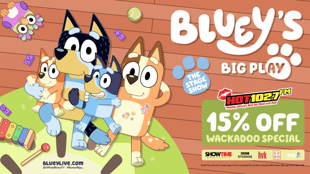Four cartoon dogs from Bluey sit together on a playroom floor, surrounded by toys. Text promotes Blueys Big Play stage show and a 15% off Wackadoo Special offer with HOT102.7 FM. Dont miss the excitement of Big Play fun!.