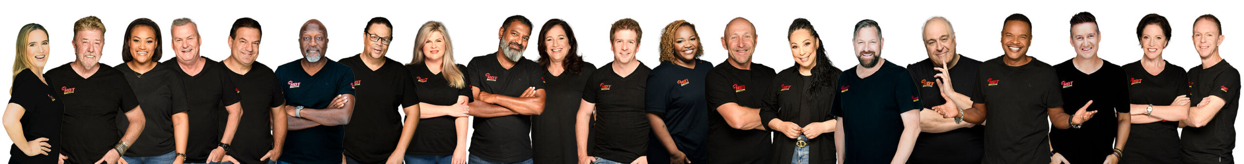 A The Hot Fm stand side by side, smiling in matching black shirts with a red logo and “Advertise with HOT 1027” beneath. Posing against a plain white background, some have arms crossed; others have hands by their sides.