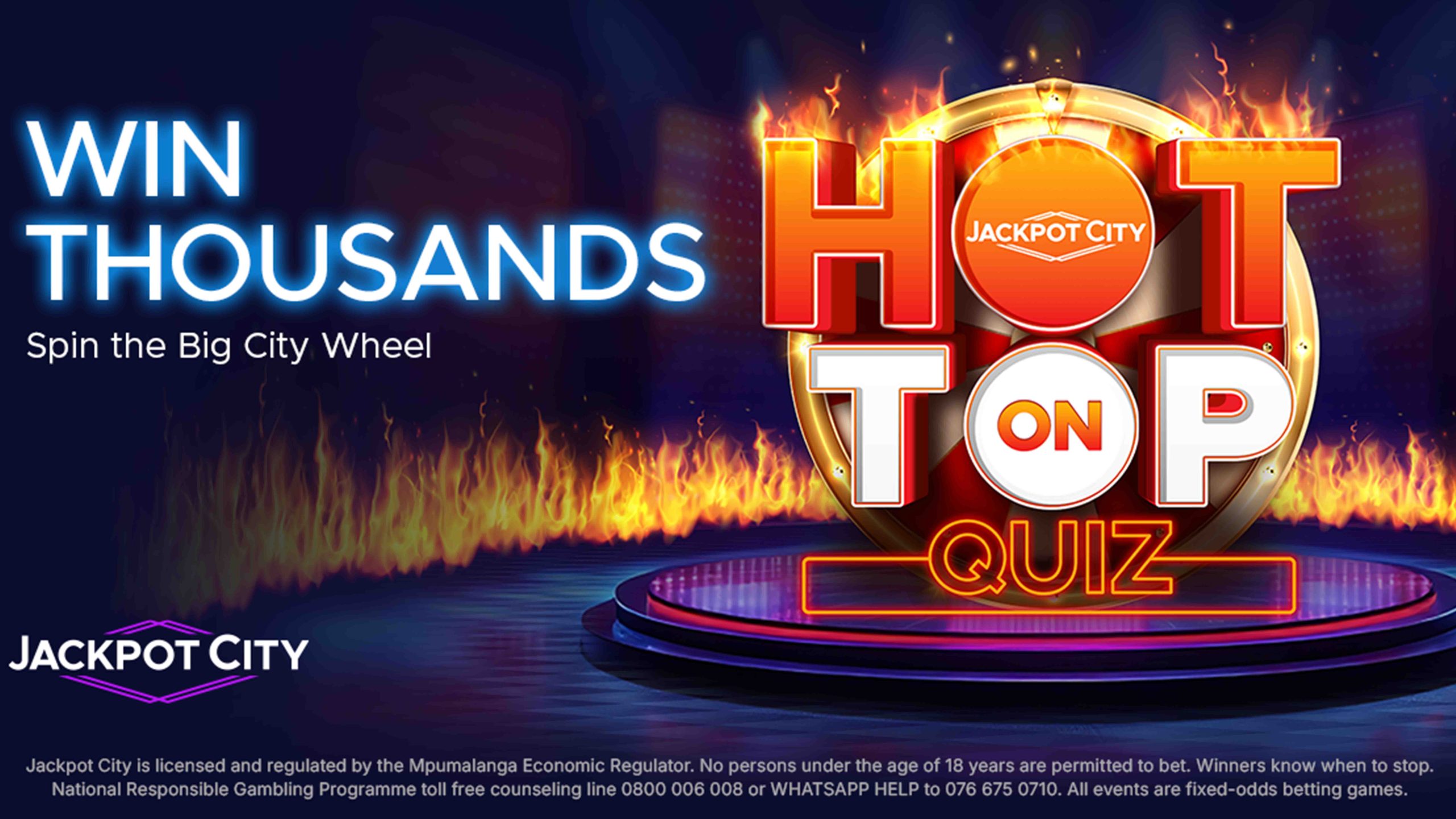 Stage with bright lights and flames, displaying Win Thousands, HOT ON TOP QUIZ, and Spin the Big City Wheel. JackpotCity logo appears below with fine print about age restrictions and regulations.