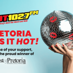 A woman holding a disco ball stands beneath the Olivedale Windmill, blending vintage charm with modern flair.