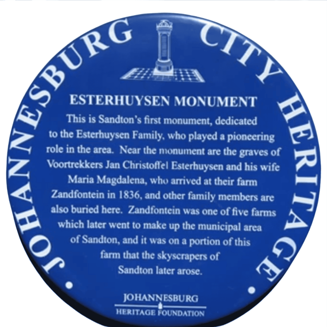 A round blue plaque titled Esterhuysen Monument from the Johannesburg City Heritage Foundation, describing the monument’s dedication to the Esterhuysen family and its historical significance in Sandton near the Magaliesberg region.