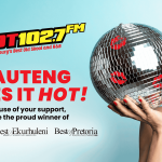 A woman in red lipstick kisses a disco ball against a blue background. Text reads HOT 102.7 FM and GAUTENG LIKES IT HOT! Proud winner of Best of Joburg, Ekurhuleni, and Best of Pretoria awards.