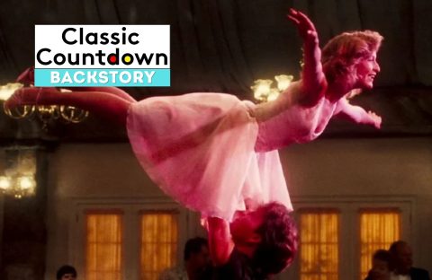 A woman in a pink dress is lifted in the air by her dance partner in a ballroom scene, capturing a moment where Love is in the Air. The words “Classic Countdown Backstory” appear in a box in the upper left corner of the image.