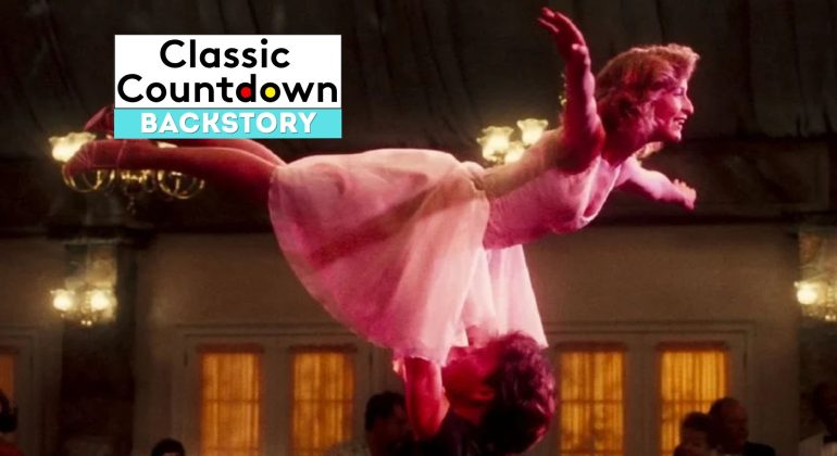 A woman in a pink dress is lifted in the air by her dance partner in a ballroom scene, capturing a moment where Love is in the Air. The words “Classic Countdown Backstory” appear in a box in the upper left corner of the image.