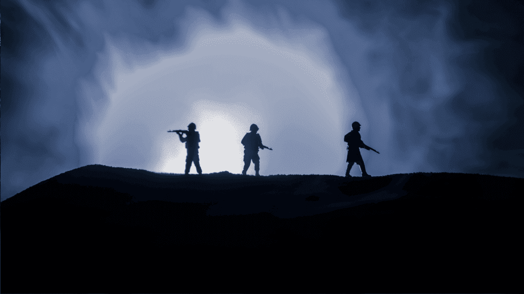 Three armed soldiers are silhouetted against a bright, smoky blue light, standing on a hill in the Magaliesberg, with a dramatic, cloudy sky behind them.