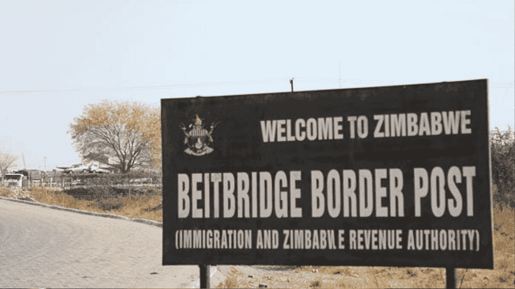 A large sign reads “Welcome to Zimbabwe. Beitbridge Border Post (Immigration and Zimbabwe Revenue Authority)” next to a paved road, with trees and dry grass in the background, highlighting potential business opportunities at this busy crossing.