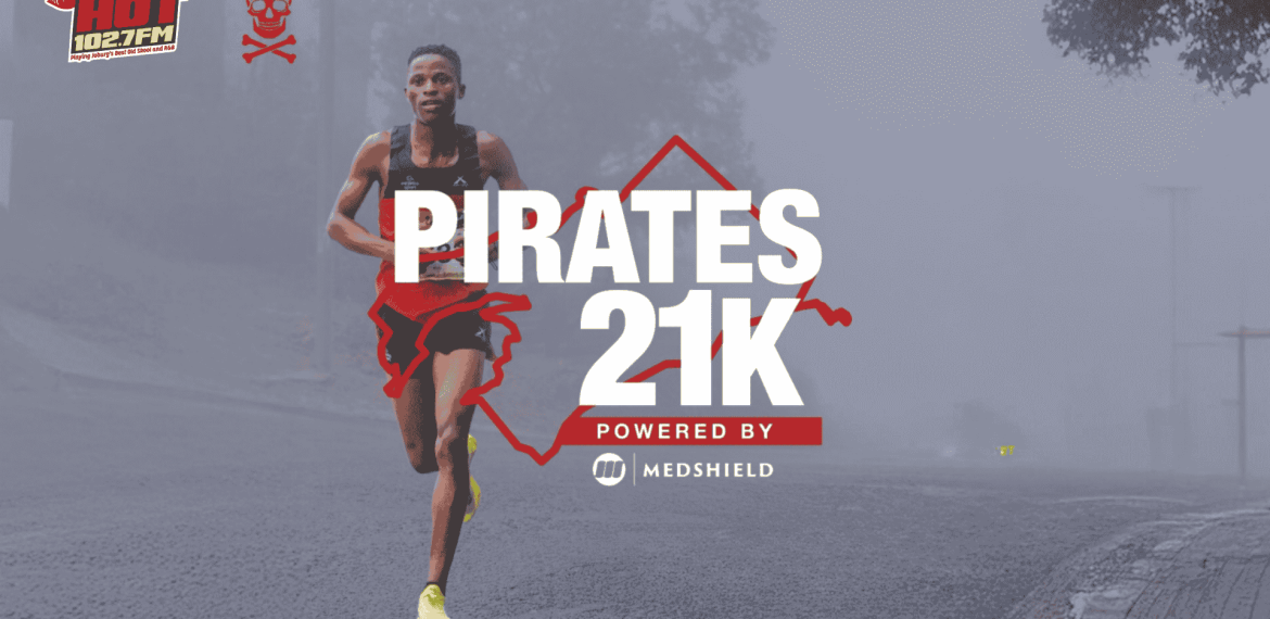 A male runner in athletic gear runs on a misty road. Bold text reads PIRATES 21K Powered by Medshield. Logos for HOT 102.7FM, Die Kantoor, and Pirates are visible, with a faint cityscape in the background.