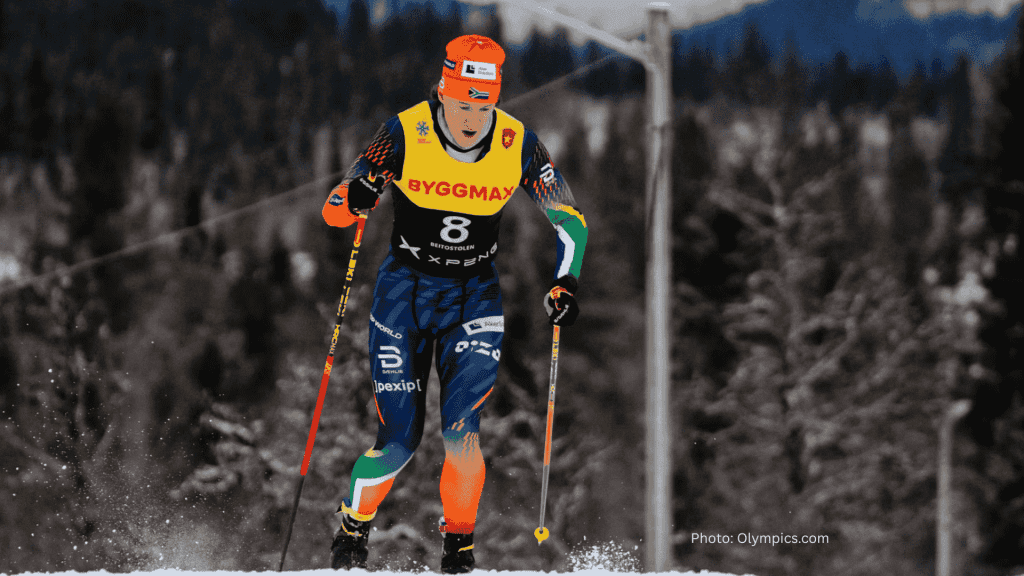 A cross-country skier in colorful gear and a numbered bib skis through a snowy forest, dreaming of a hot 1027 breakfast, with pine trees and mountains blurred in the background.