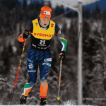 A cross-country skier in colorful gear and a numbered bib skis through a snowy forest, dreaming of a hot 1027 breakfast, with pine trees and mountains blurred in the background.