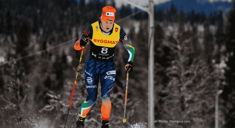 A cross-country skier in colorful gear and a numbered bib skis through a snowy forest, dreaming of a hot 1027 breakfast, with pine trees and mountains blurred in the background.