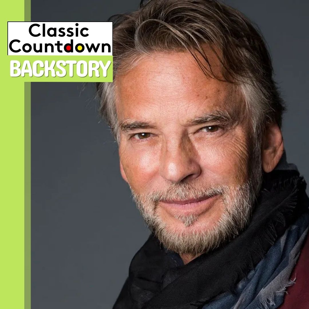 A man with gray hair and a beard smiles softly at the camera. The image has a green border, and text reads Classic Countdown Backstory in the top left corner, hinting at memories from Last Christmas.