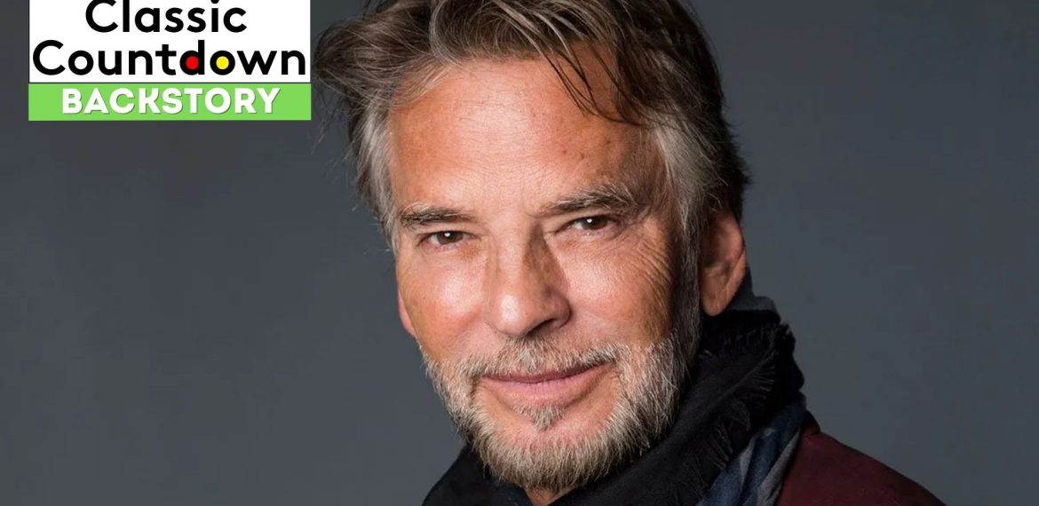 A man with gray hair and a trimmed beard smiles softly at the camera, wearing a dark scarf and jacket. "Classic Countdown Backstory" and "Last Christmas" are displayed in the top left corner on a black, white, and green background.