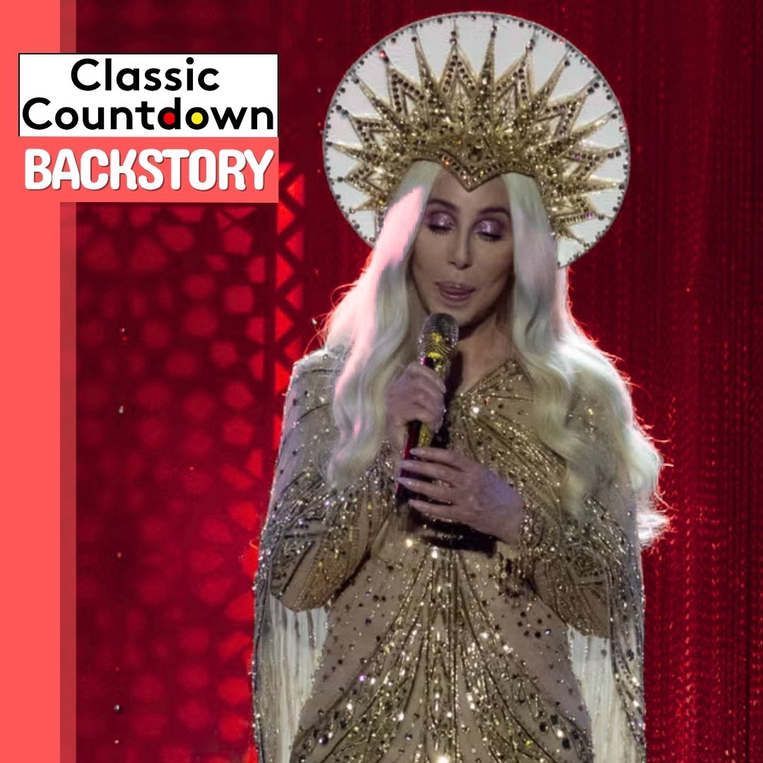 A performer with long blonde hair and a gold, starburst headdress sings "Last Christmas" into a microphone while wearing a sparkling gold outfit. The background is red with a Classic Countdown Backstory logo in the corner.