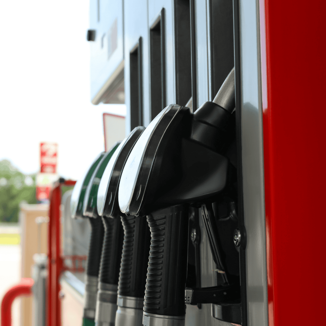 Close-up of fuel pump nozzles at a gas station, with black and green handles ready for refueling—much like a new show lineup, each offers a choice to fuel your journey.