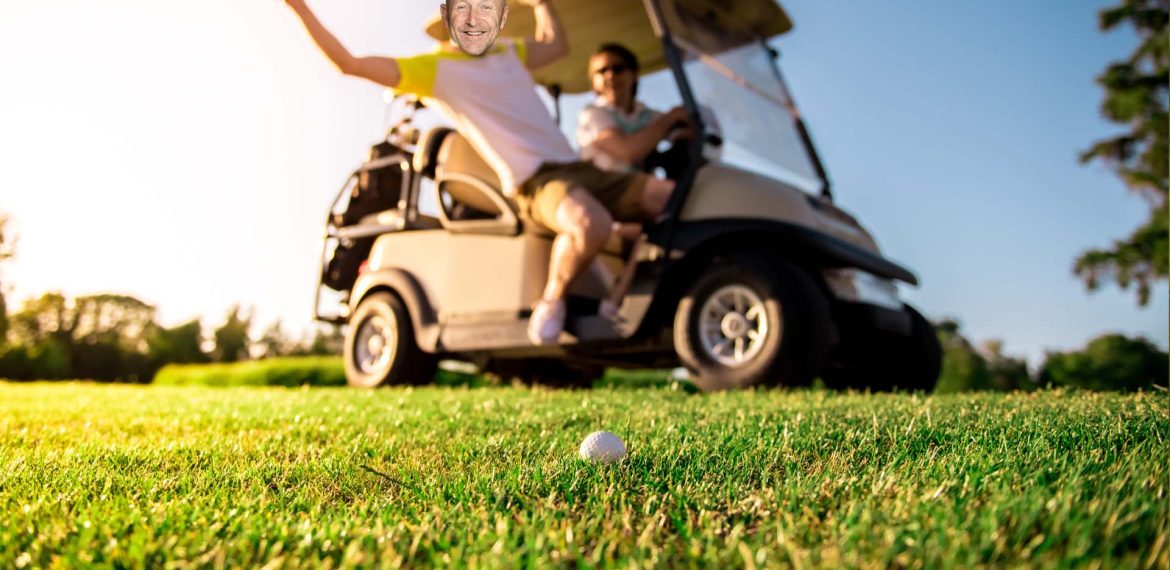 Two people are near a golf cart on a sunny golf course. One person is swinging a golf club, smiling, while the other watches from the driver’s seat—enjoying their morning with Hot 1027 Breakfast as a golf ball sits on the grass in the foreground.