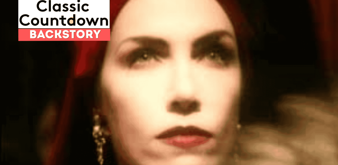 A close-up of a woman with red lipstick and a red headscarf, wearing drop earrings. The image is softly focused. Overlay text reads “Classic Countdown Backstory” in bold white and black letters on a red and white background.