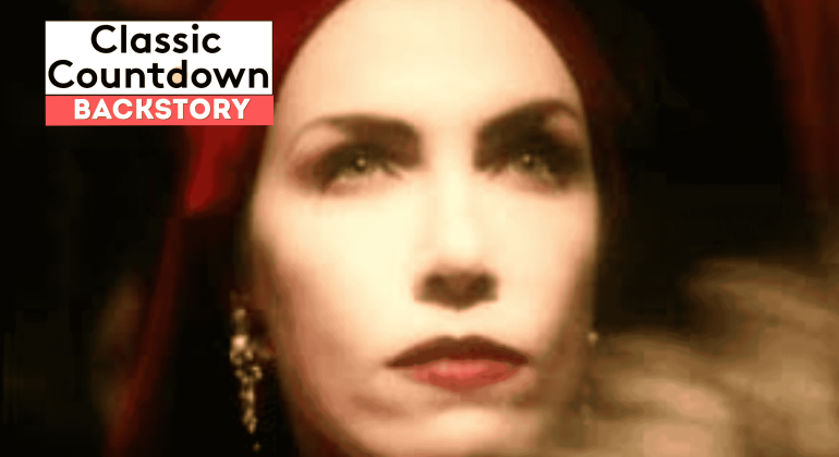 A close-up of a woman with red lipstick and a red headscarf, wearing drop earrings. The image is softly focused. Overlay text reads “Classic Countdown Backstory” in bold white and black letters on a red and white background.