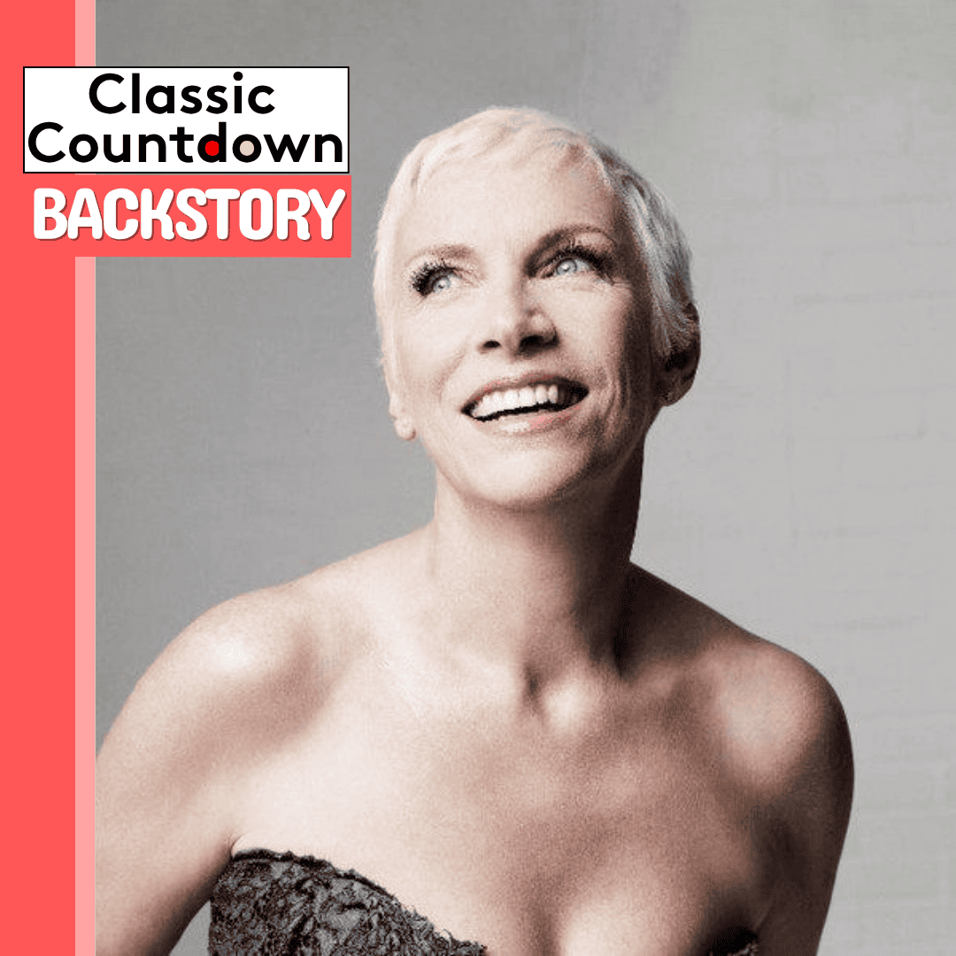 A smiling woman with short, platinum blonde hair and bare shoulders poses against a gray background, reminiscent of Janet Jackson's iconic style. Text in the top left corner reads Classic Countdown BACKSTORY with a red and white color scheme.