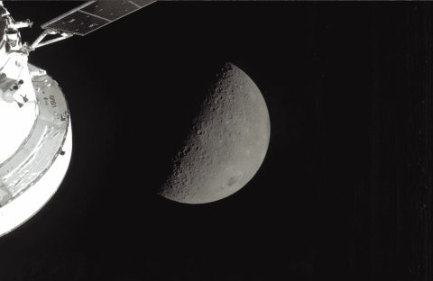 A spacecraft orbits the Moon, capturing a detailed view of the lunar surface with craters visible on the sunlit half, while improved fuel relief ensures efficient travel through the vast blackness of space.