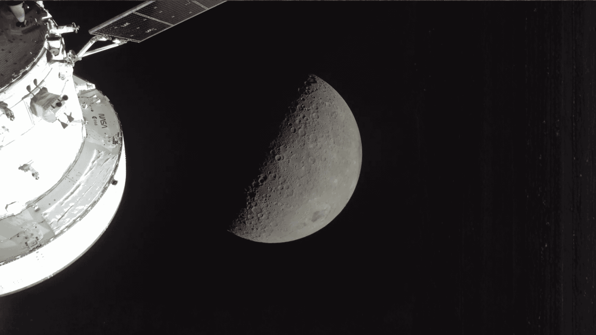 A spacecraft orbits the Moon, capturing a detailed view of the lunar surface with craters visible on the sunlit half, while improved fuel relief ensures efficient travel through the vast blackness of space.