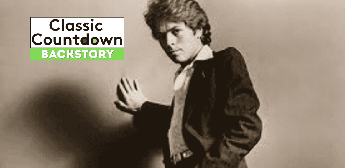 A young man in a suit poses with one hand pressed against a wall. The words Classic Countdown Backstory appear in bold text, with Backstory highlighted in green on the left side of the image.