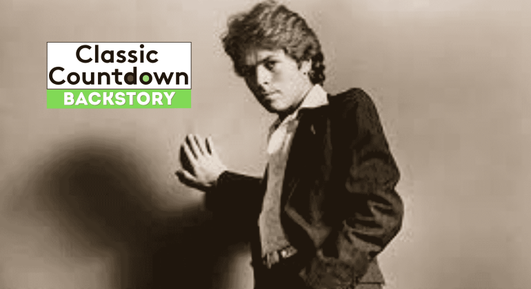 A young man in a suit poses with one hand pressed against a wall. The words Classic Countdown Backstory appear in bold text, with Backstory highlighted in green on the left side of the image.