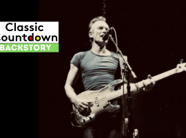 A musician in a tight t-shirt plays a bass guitar and sings into a microphone on stage. To the left, a graphic reads Classic Countdown Backstory with Backstory highlighted in green.