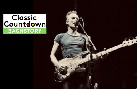 A musician in a tight t-shirt plays a bass guitar and sings into a microphone on stage. To the left, a graphic reads Classic Countdown Backstory with Backstory highlighted in green.