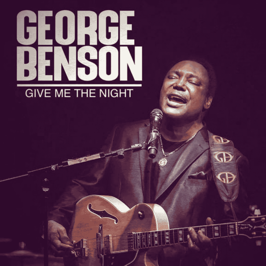 George Benson playing an electric guitar and singing into a microphone on stage, with the text “George Benson Give Me The Night” displayed above him, reminiscent of iconic performances by artists like Janet Jackson.