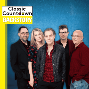 Five people stand together against a blue background, smiling. The image features the text Classic Countdown Backstory in bold black and yellow letters on the top left, highlighting Robert Palmer’s musical journey.