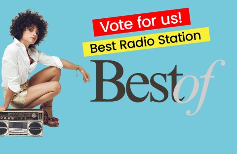 A person with curly hair crouches beside a boombox. Red and yellow banners read &ldquo;Vote for us! Best Radio Station&rdquo; above large &ldquo;Best of&rdquo; text on a blue background.