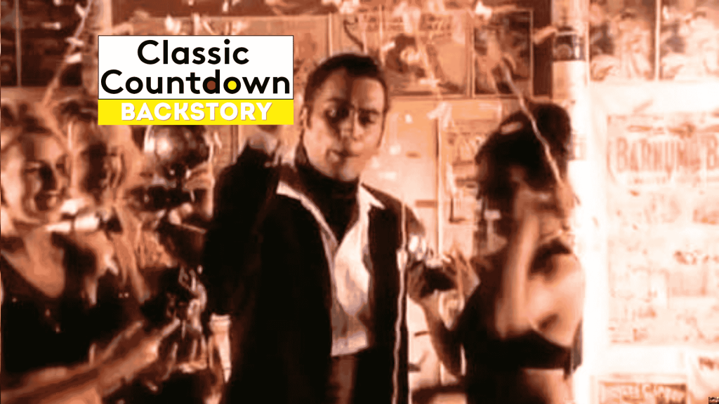 A man in a suit, reminiscent of Robert Palmer, stands in the center, surrounded by women with confetti falling. The words Classic Countdown Backstory appear in a bold white and yellow box at the top left.
