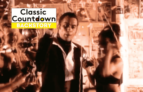 A man in a suit, reminiscent of Robert Palmer, stands in the center, surrounded by women with confetti falling. The words Classic Countdown Backstory appear in a bold white and yellow box at the top left.