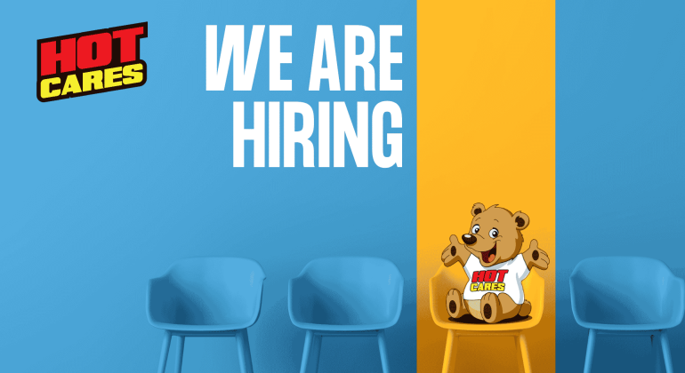 Blue chairs against a blue and yellow wall set the scene, with “We Are Hiring” written in large white text. A cartoon bear wearing a Hot Cares shirt sits on a yellow chair, inviting applicants to join our caring team. The Hot Cares logo appears in the top left corner as we continue our mission to support important causes like Shona breast cancer awareness.