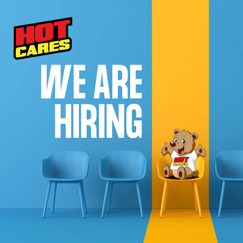 Three blue chairs and one yellow chair with a teddy bear are against a blue and yellow wall. Text says HOT CARES and WE ARE HIRING. The teddy bear holds a HOT CARES logo, radiating warmth and support similar to Shona breast cancer awareness initiatives.
