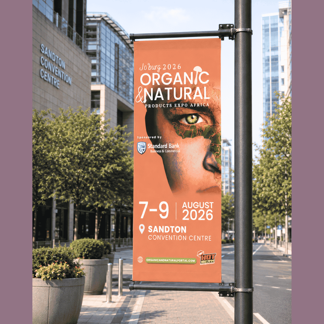 A street banner advertises the Joburg 2026 Organic & Natural Products Expo Africa, held at Sandton Convention Centre, August 7-9, 2026, featuring a close-up of a persons face and event details.
