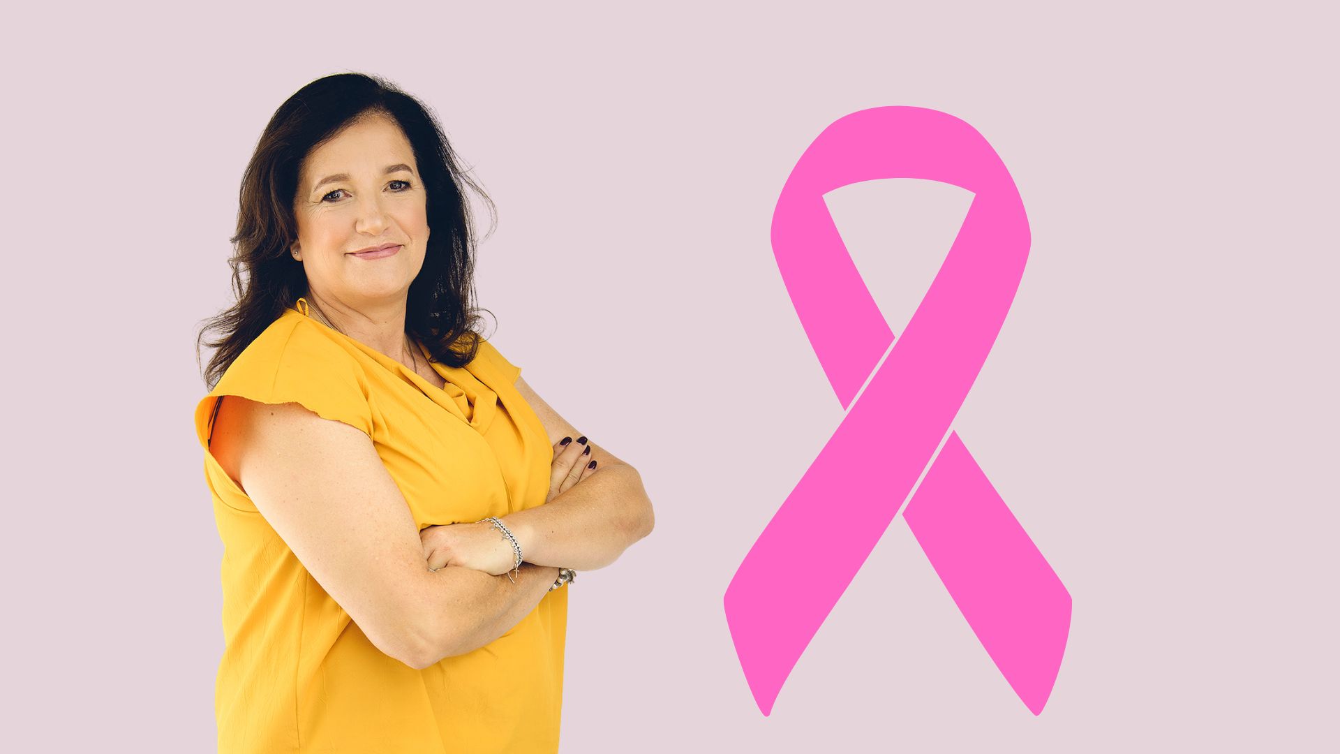 A woman in a yellow top stands with arms crossed, smiling, next to a large pink Shona breast cancer awareness ribbon on a light purple background.
