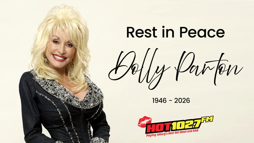A smiling woman with blonde hair in a sparkly black outfit stands next to text that reads, Rest in Peace Dolly Parton 1946-2026, with a HOT 102.7 FM radio logo below.